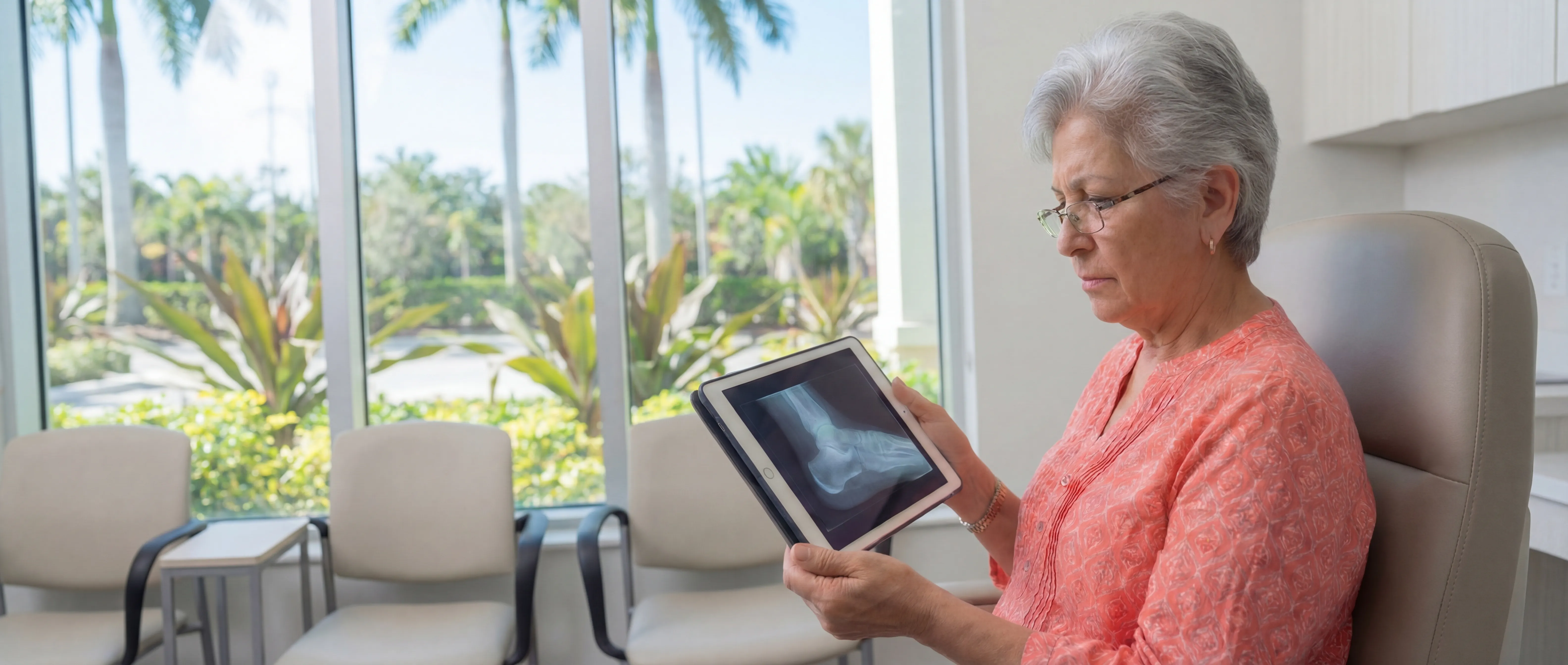 Heel spur diagnosis in Miami: patient reviewing foot X-ray at a South Florida clinic