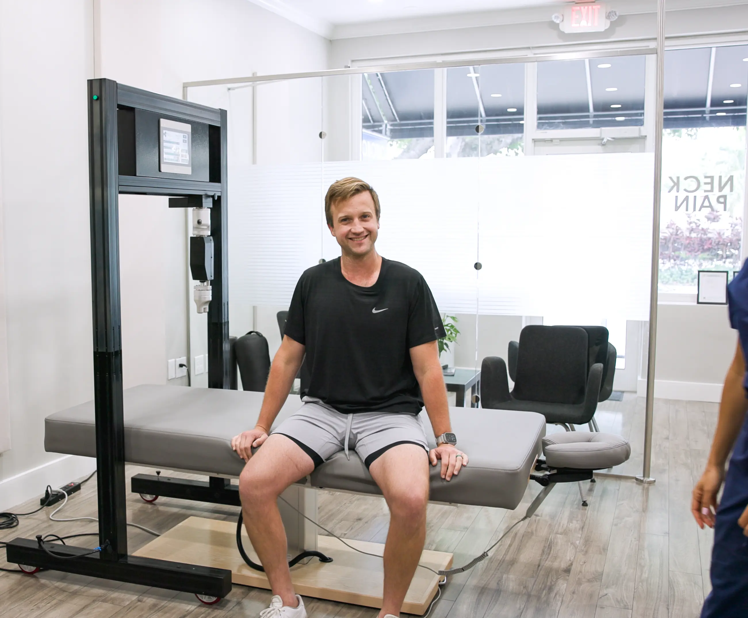 Friendly TheraMax therapist ready to help with robotic therapy